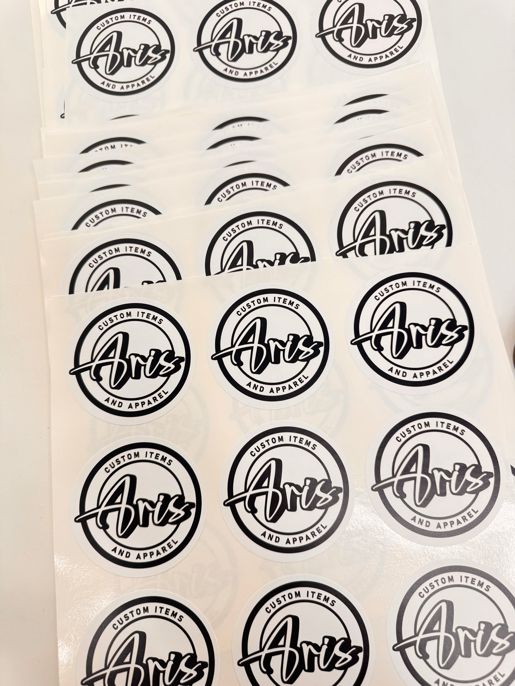 Sheet of black 'Aris' logo stickers on a white background